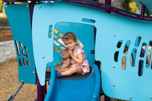 A young girl ready to go down the slide at Govalle Neighborhood Park.