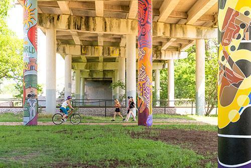 Walkers and bikers enjoying the East Link Trail in East Austin outside of Rosewood Park.