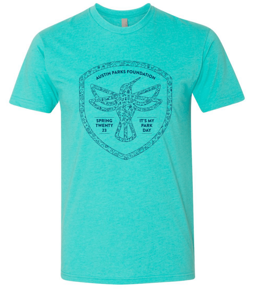Light blue t-shirt with dark blue hummingbird illustration inside of a shield. Shirt text reads Austin Parks Foundation, Spring Twenty 23, It's My Park Day.